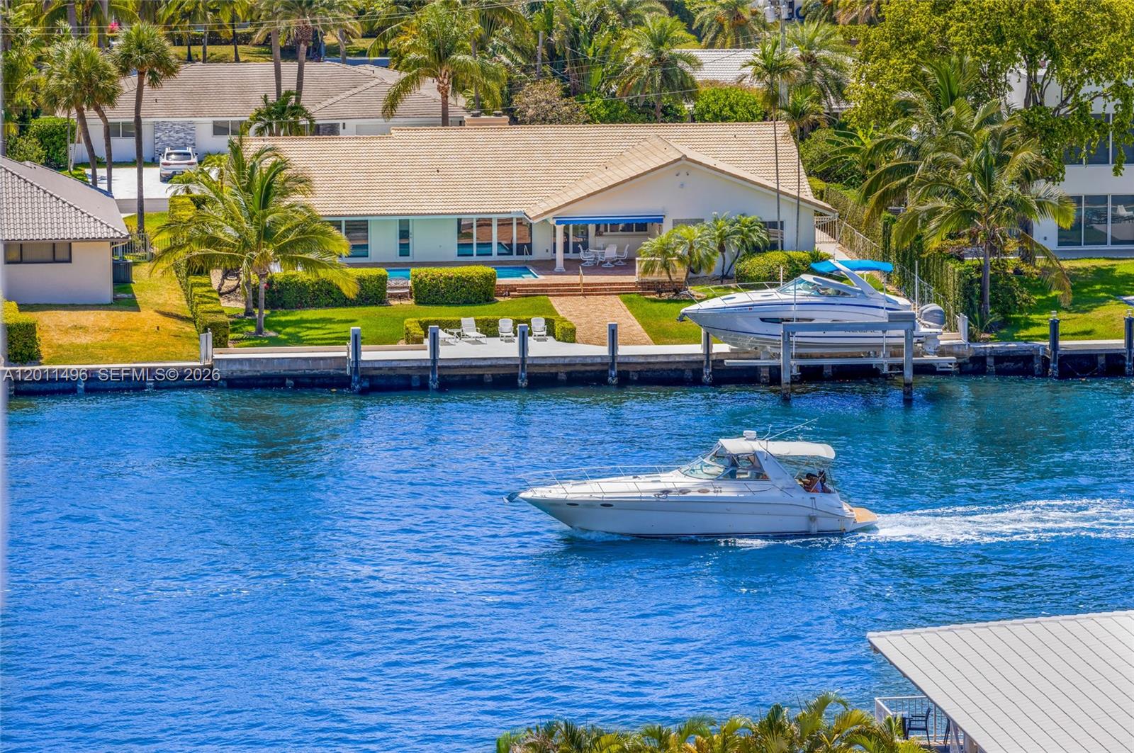 An aerial view shows a waterfront house with a pool, dock, and boat — 1985 S Ocean Dr # 10B, Hallandale Beach FL 33009, HALLANDALE BEACH, FL