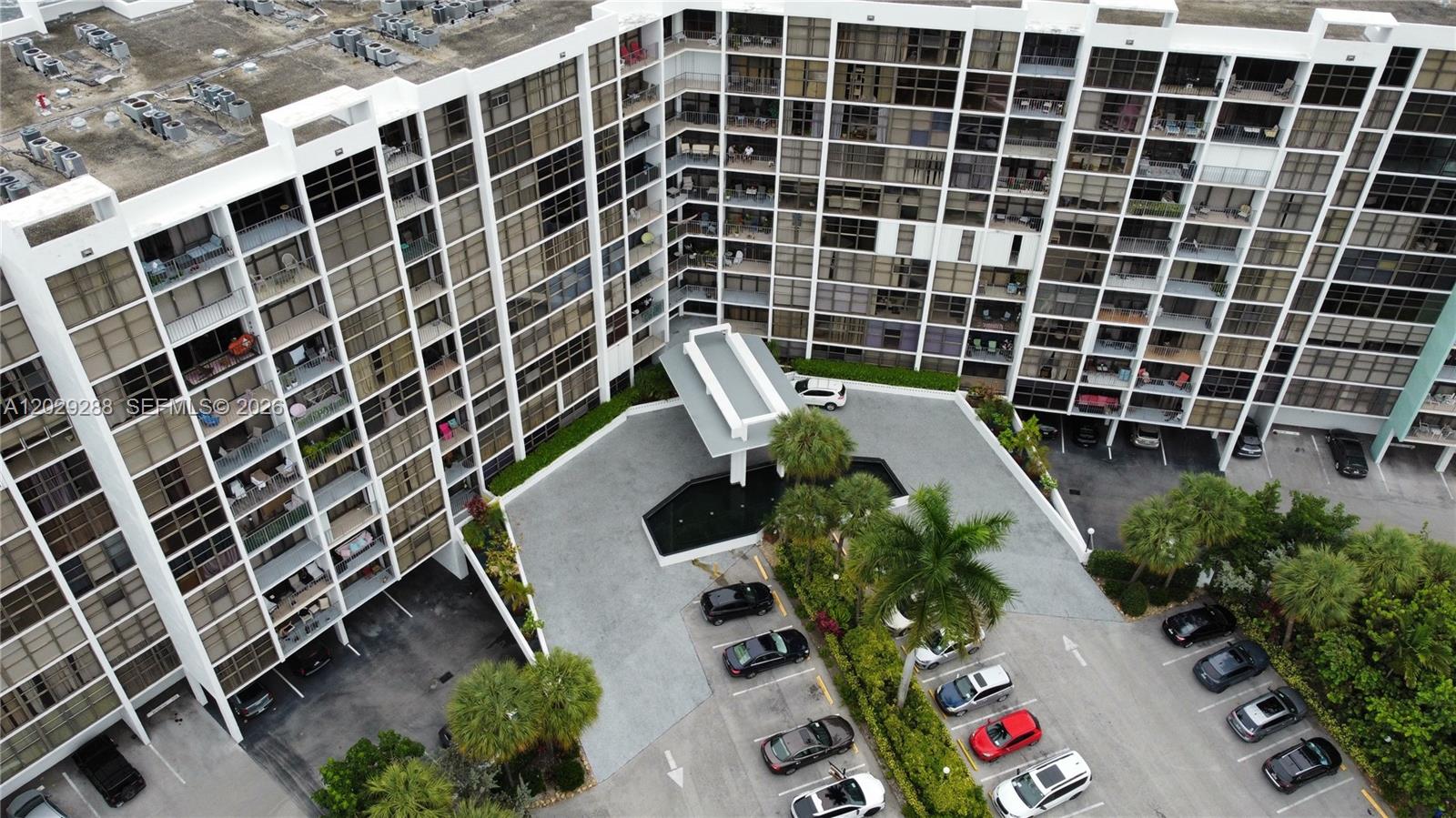 An aerial view shows a large apartment complex with a central driveway and parking lot — 400 Leslie Dr # 416, Hallandale Beach FL 33009, HALLANDALE BEACH, FL