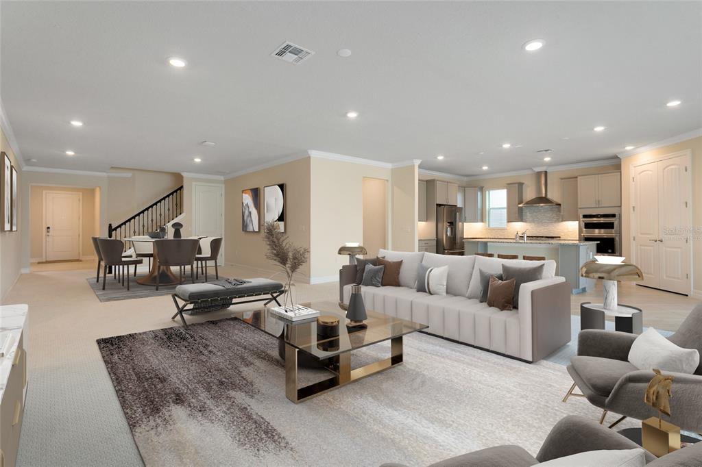 An open-concept living room and dining area feature neutral walls, recessed lighting, and modern furniture — 9212 HANGING VINE COURT, ORLANDO, FL