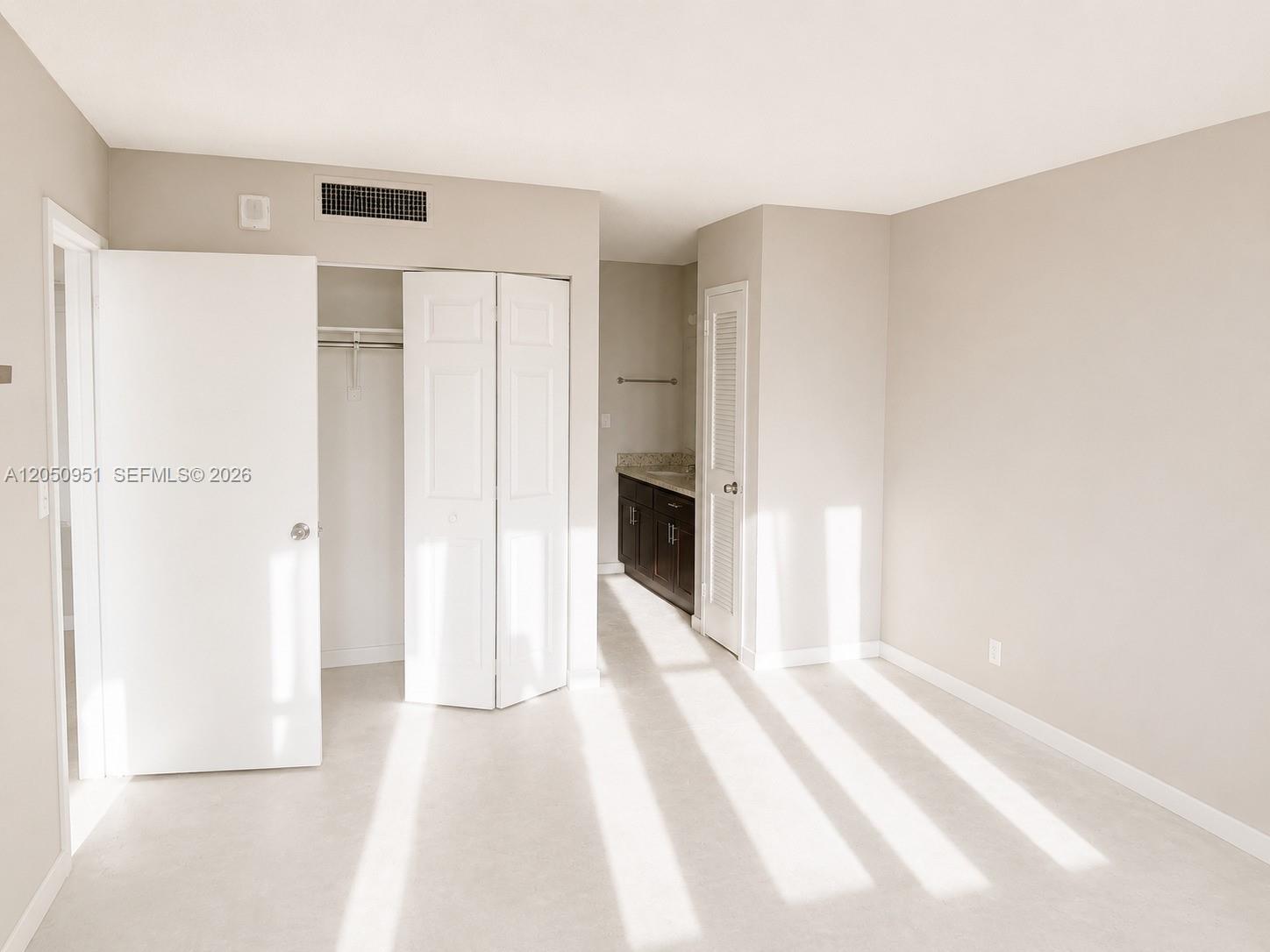 A bedroom features a closet, a vanity area, and light-colored flooring — 2030 S Ocean Dr # 1503, Hallandale Beach FL 33009, HALLANDALE BEACH, FL