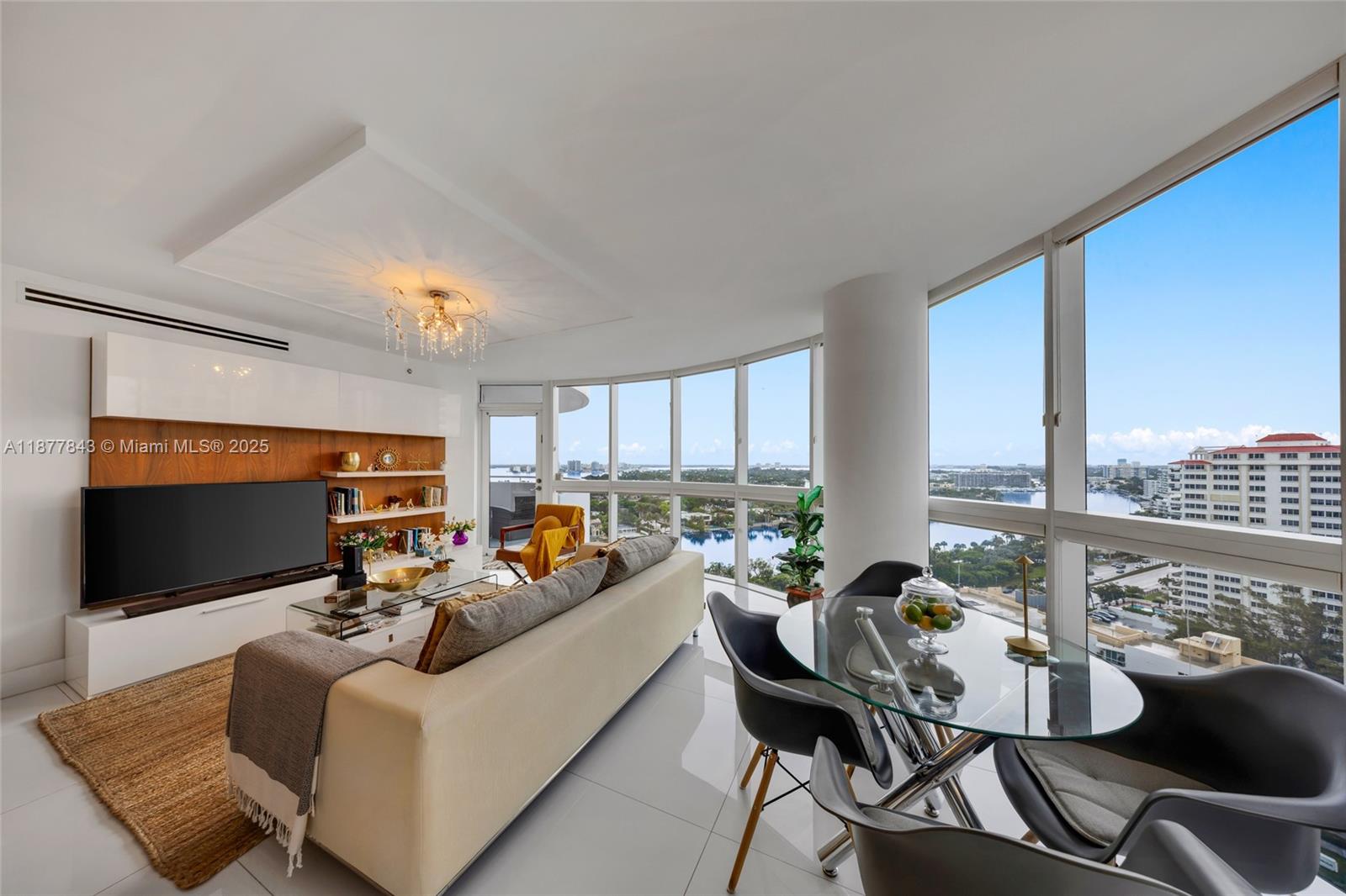 A modern living and dining room with floor-to-ceiling windows overlooking a coastal city view — 6301 Collins Ave # 2107, Miami Beach FL 33141, MIAMI BEACH, FL