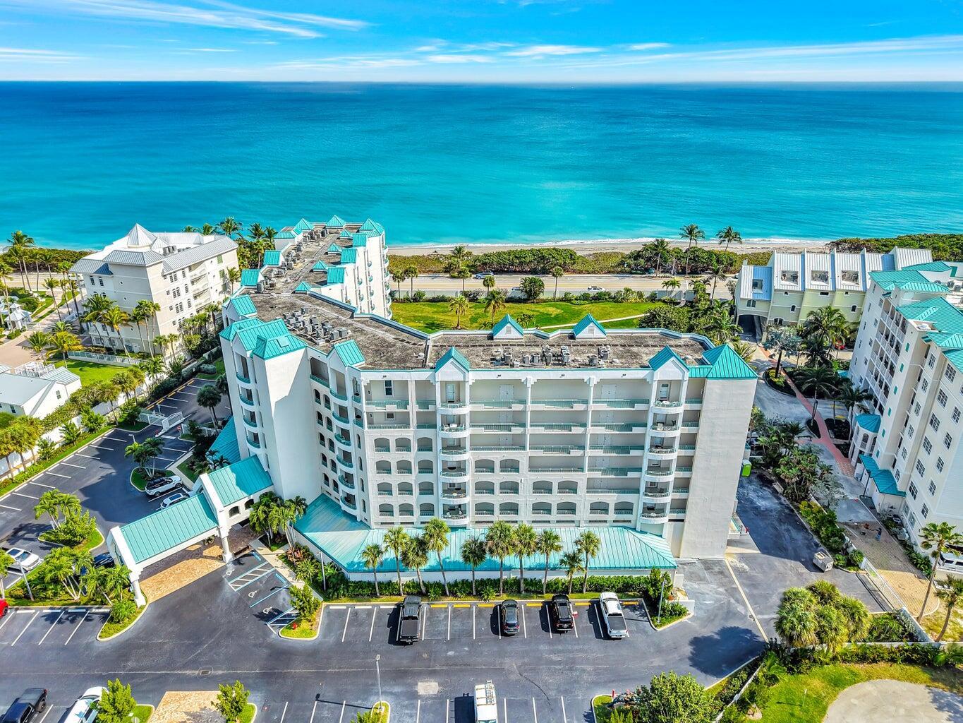 An aerial view of a multi-story beachfront resort building with a parking lot — 2000 S Highway A1a # 406, Jupiter FL 33477, JUPITER, FL