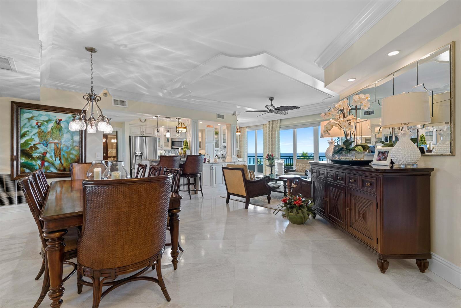 A spacious open-concept living and dining area features tile floors, a kitchen, and ocean views — 2000 S Highway A1a # 406, Jupiter FL 33477, JUPITER, FL