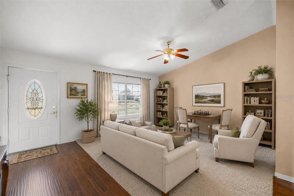 A living room features a sofa, two armchairs, a dining table, and a bookshelf — 13646 SE 91ST COURT, SUMMERFIELD, FL