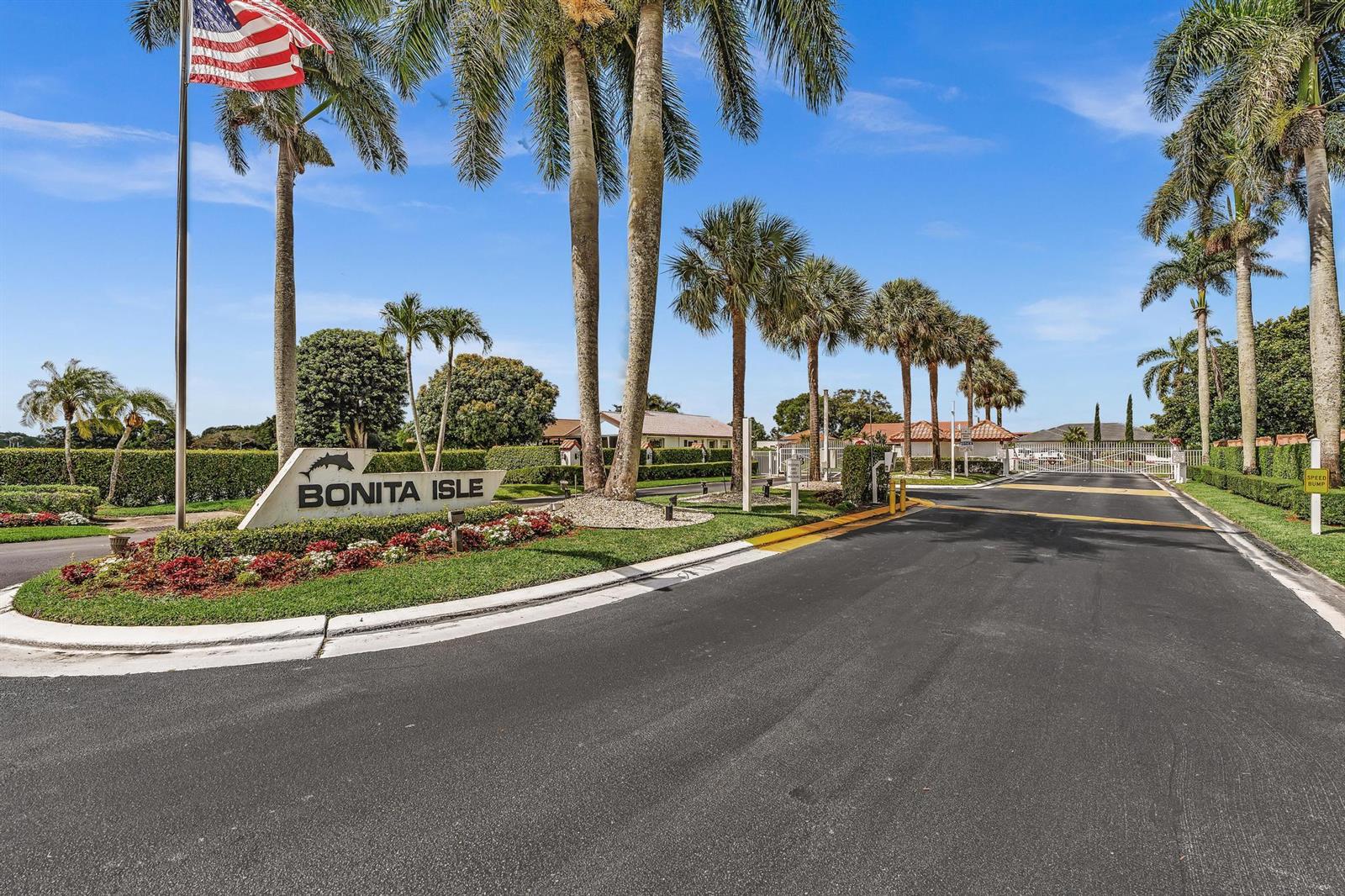 The entrance to the Bonita Isle community features a sign, palm trees, and a gate — 5463 Alta Way, Lake Worth FL 33467, LAKE WORTH, FL
