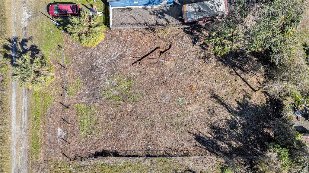 An aerial view shows a cleared, rectangular lot with a fence and surrounding vegetation — POLO STREET, NEW PORT RICHEY, FL