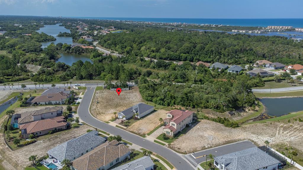 An aerial view shows a vacant residential lot marked with a pin in a neighborhood — 2 RIO VISTA DRIVE, PALM COAST, FL