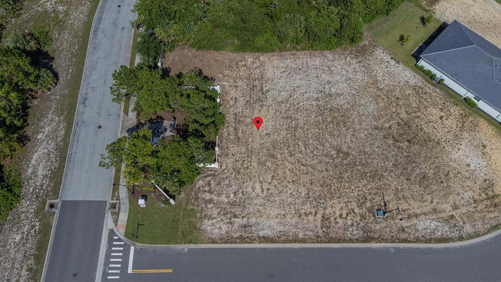 An aerial view shows a vacant, sandy residential lot situated on a corner street intersection — 2 RIO VISTA DRIVE, PALM COAST, FL