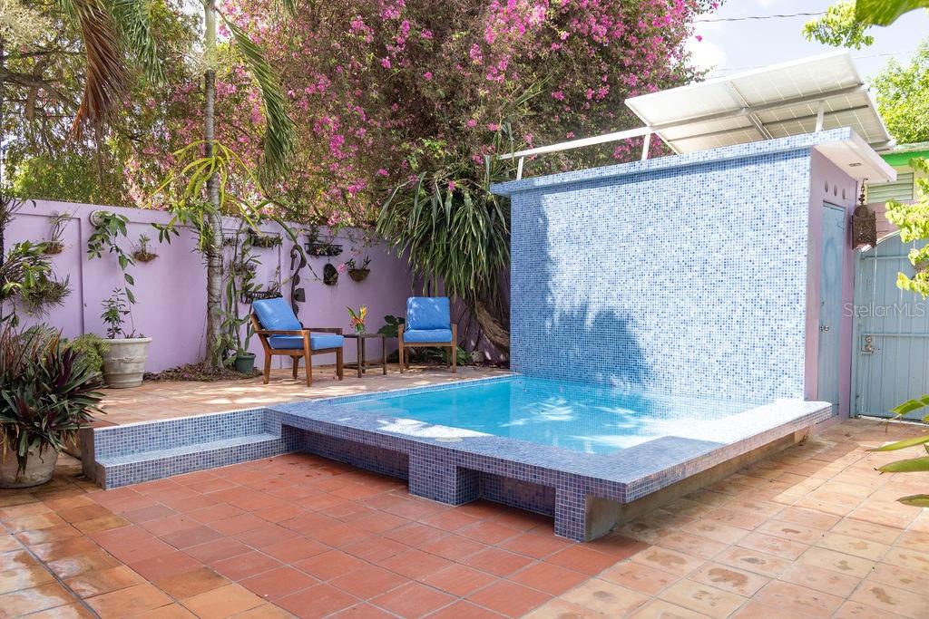 A small, tiled plunge pool sits on a patio next to a blue tiled wall — 393 CALLE JOSE SUEIRO, VIEQUES, PR