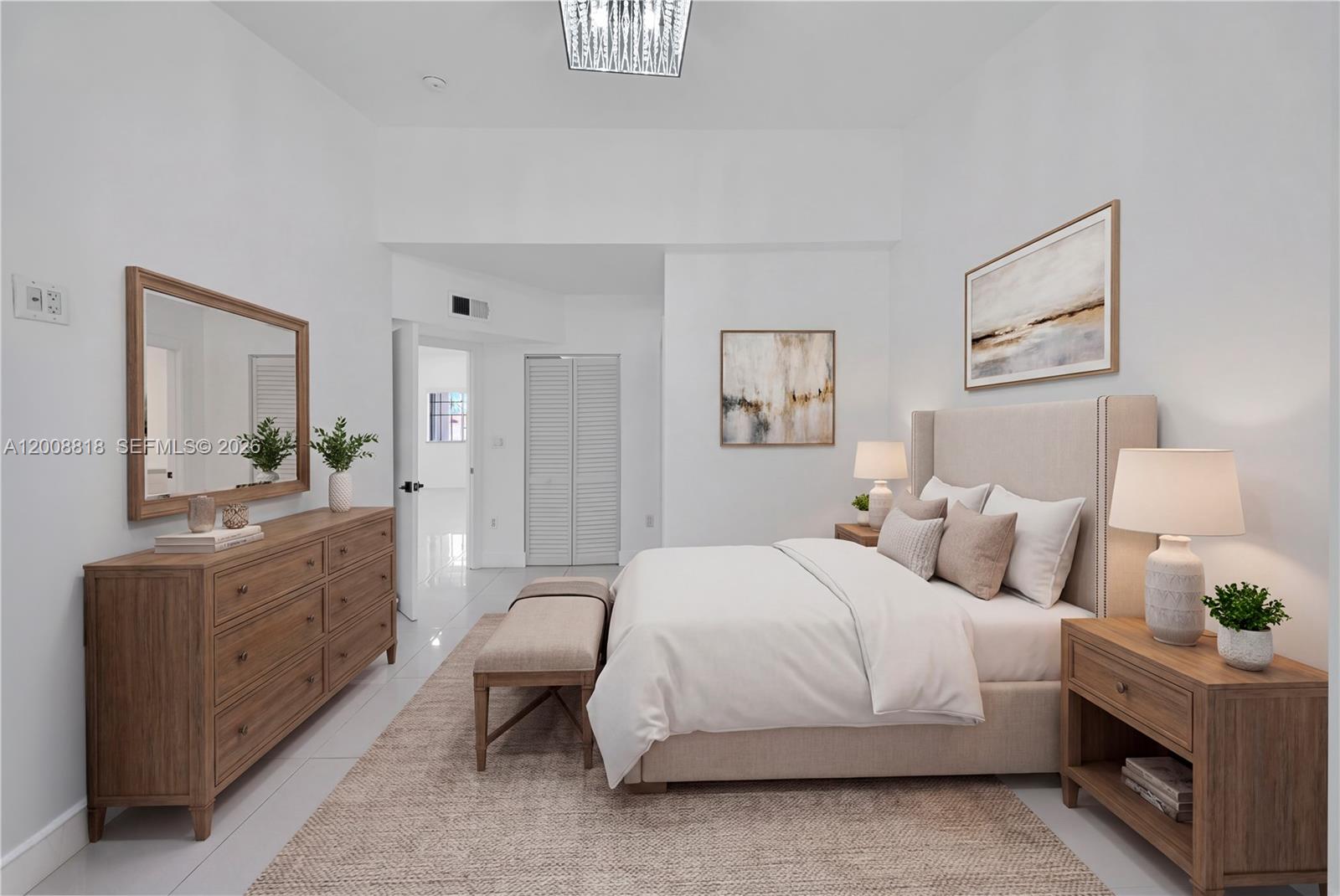 A bedroom features a beige upholstered bed, wooden furniture, and a neutral-toned area rug — 13170 SW 66 Ter # 1810B, Miami FL 33183, MIAMI, FL