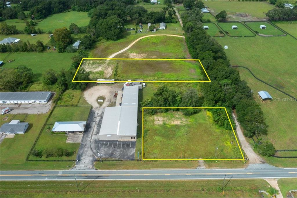 An aerial view shows a commercial building with two adjacent vacant lots outlined in yellow — 16262 S HIGHWAY 475, SUMMERFIELD, FL