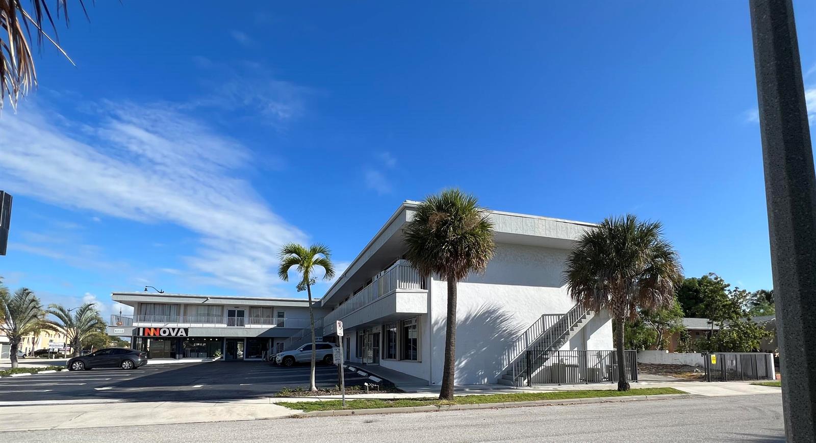A two-story commercial building with a parking lot, palm trees, and an exterior staircase — 6230 S Dixie Highway # B, West Palm Beach FL 33405, WEST PALM BEACH, FL