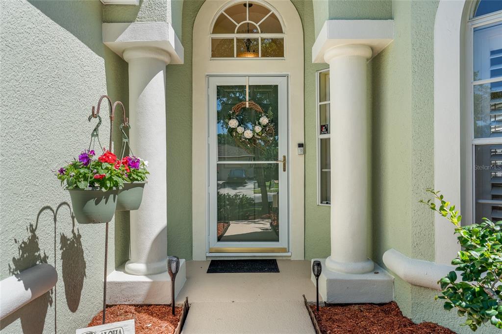 A front entryway features a white door with a wreath, flanked by two decorative columns — 2248 HILLSHIRE DRIVE, ORLANDO, FL