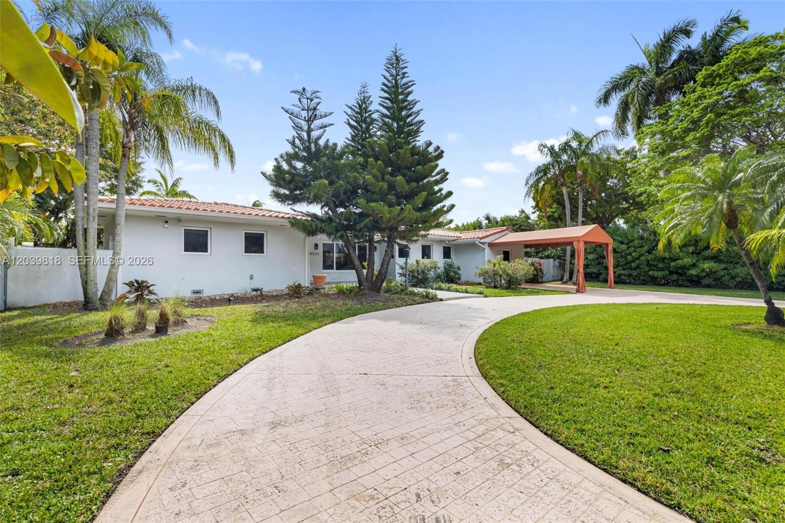 A single-story house with a white exterior, tiled roof, and a curved paved driveway — 1014 Jefferson St, Hollywood FL 33019, HOLLYWOOD, FL