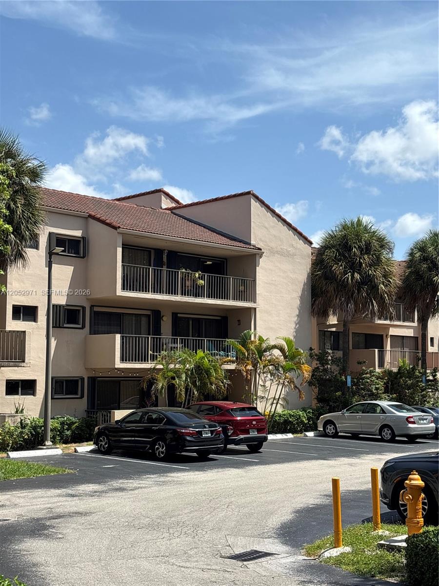 A three-story apartment building with balconies and a parking lot in front — 6305 Gage Pl # 309A, Miami Lakes FL 33014, MIAMI LAKES, FL