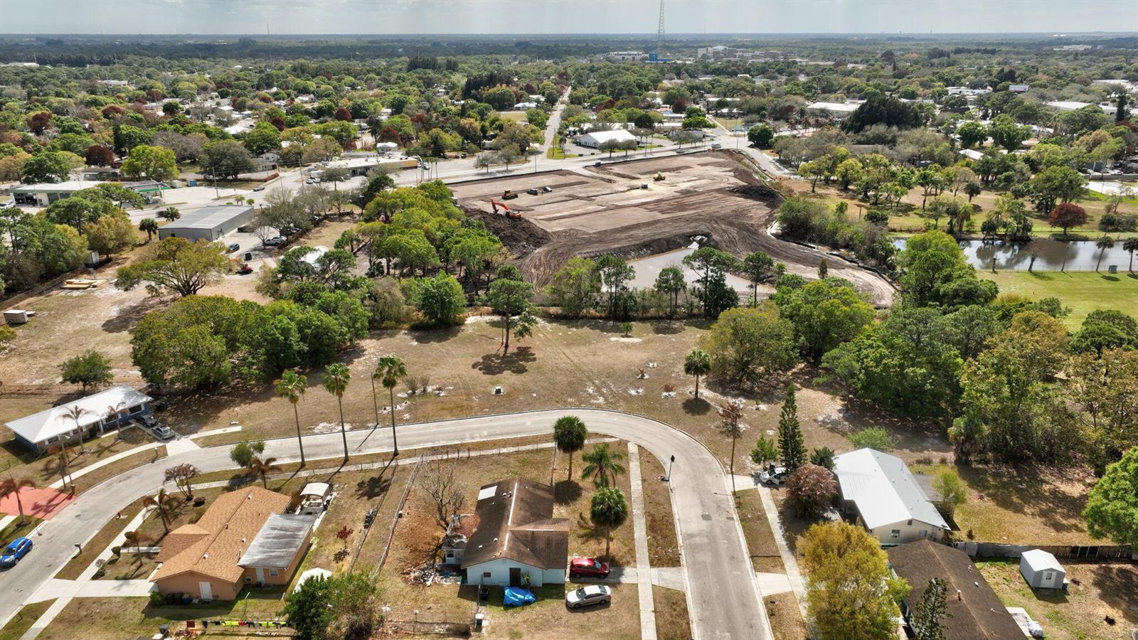 An aerial view shows a residential neighborhood with a large, cleared construction site nearby — 0 Hemlock Circle, Fort Pierce FL 34947, FORT PIERCE, FL