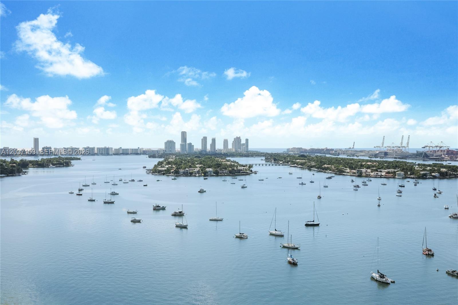 An aerial view shows a bay filled with many boats near a city skyline — 1000 Venetian Way # 1902, Miami FL 33139, MIAMI, FL