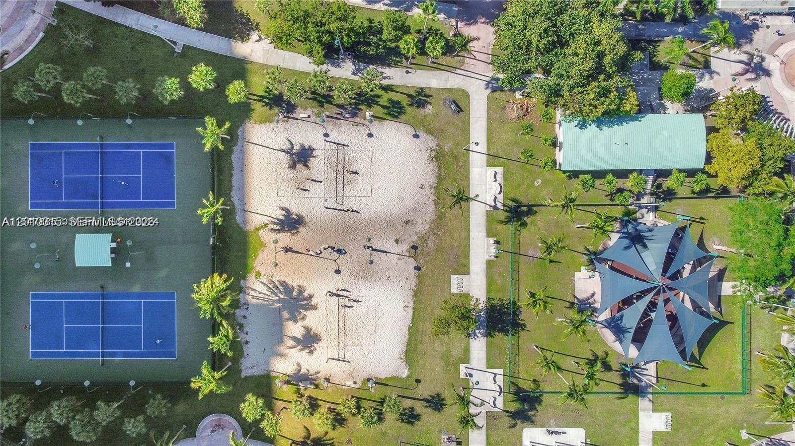 An aerial view shows a park with two tennis courts, two sand volleyball courts, and a pavilion — 488 NE 18th St # 301, Miami FL 33132, MIAMI, FL