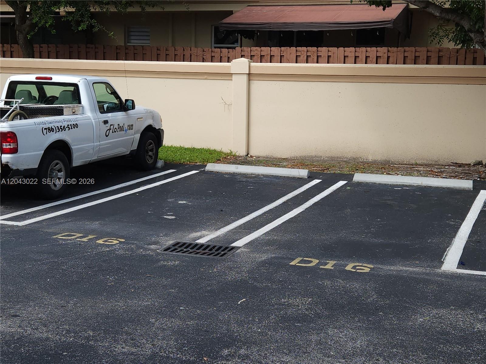 A white pickup truck is parked in a marked space next to a concrete wall — 13331 SW 132 AVE # 16, Miami FL 33186, MIAMI, FL