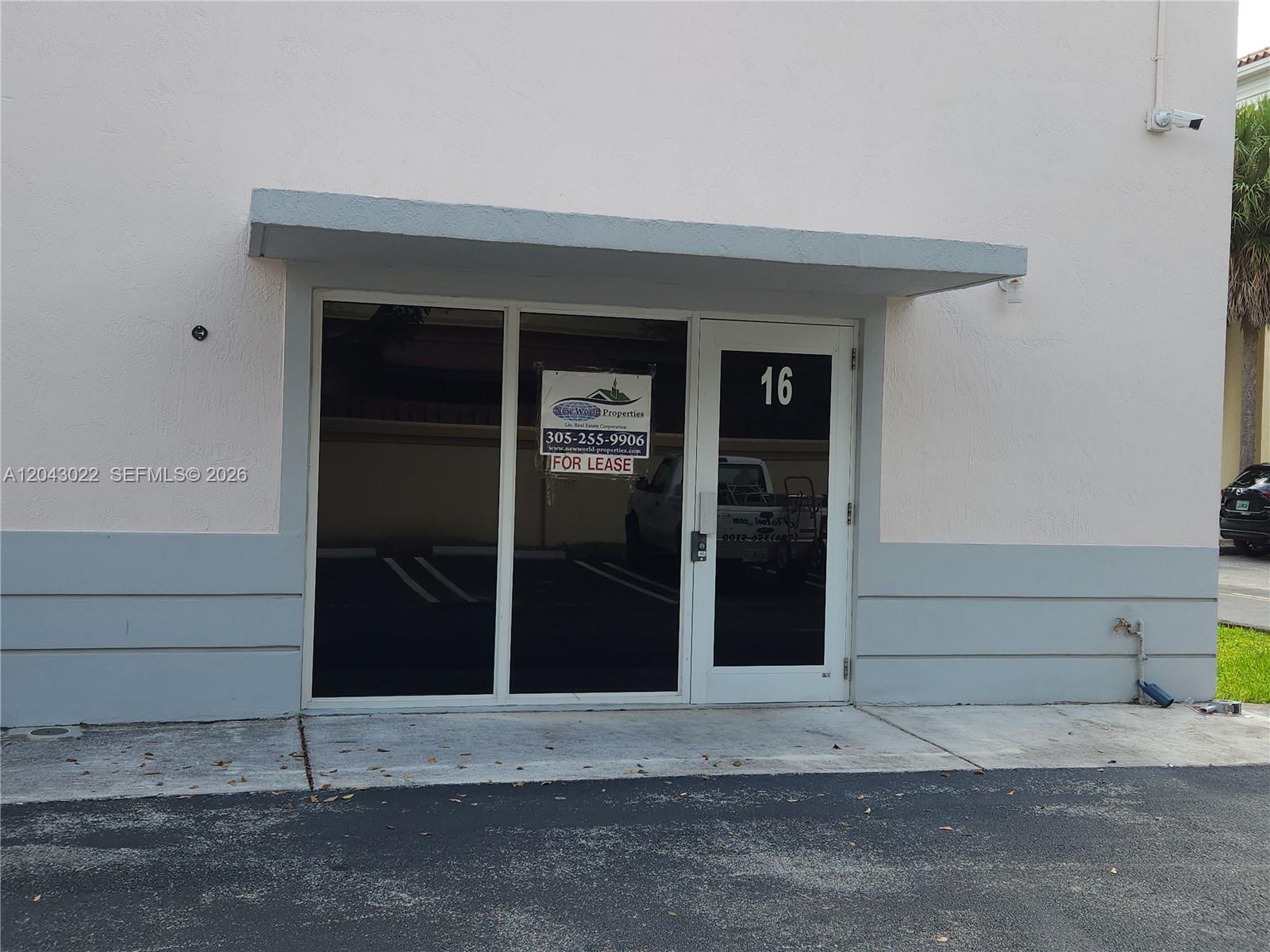 The exterior of a commercial building unit features a glass door labeled 16 and a lease sign — 13331 SW 132 AVE # 16, Miami FL 33186, MIAMI, FL