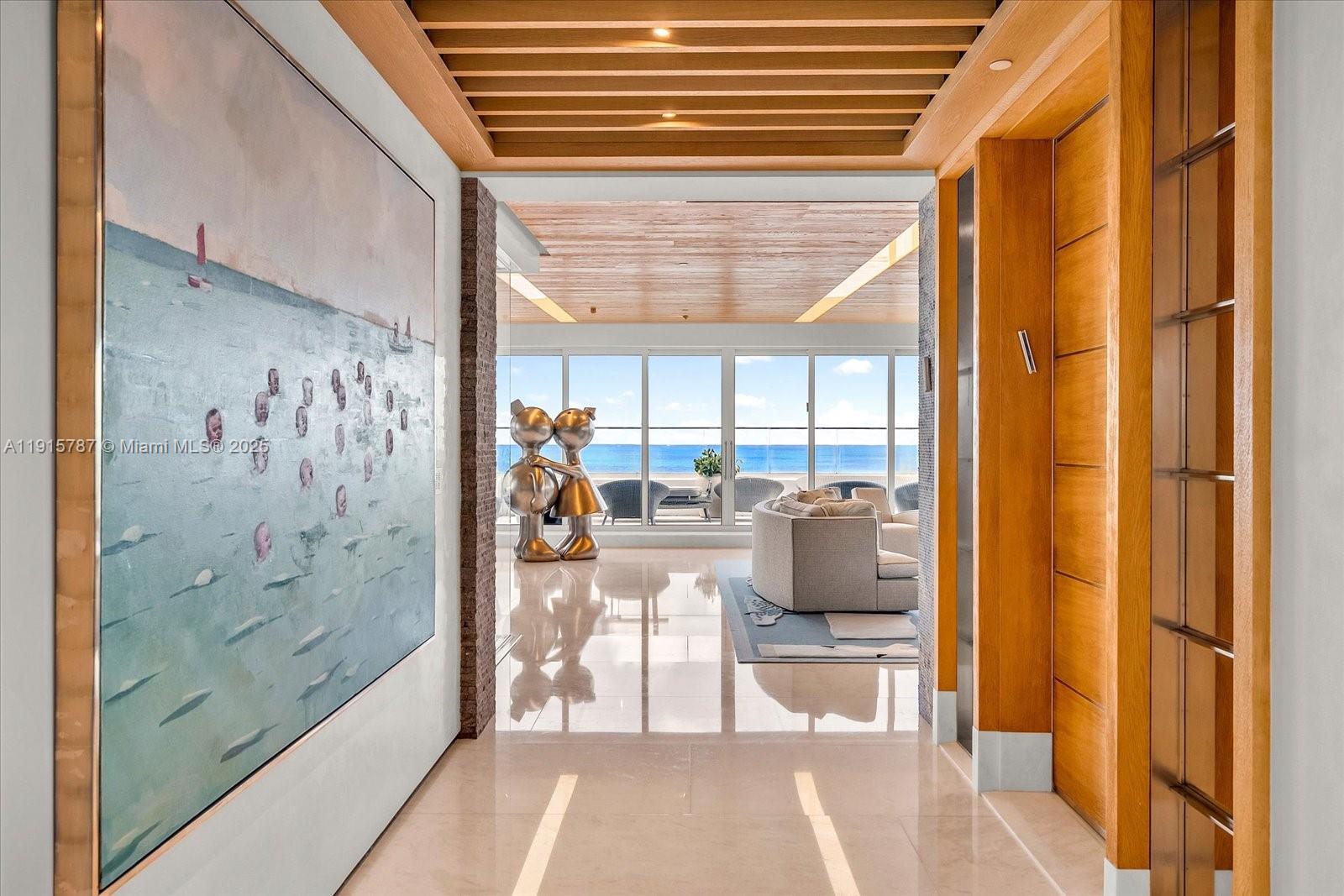 A hallway with a large painting leads to a living area overlooking the ocean — 430 Grand Bay Dr, Key Biscayne FL 33149, KEY BISCAYNE, FL
