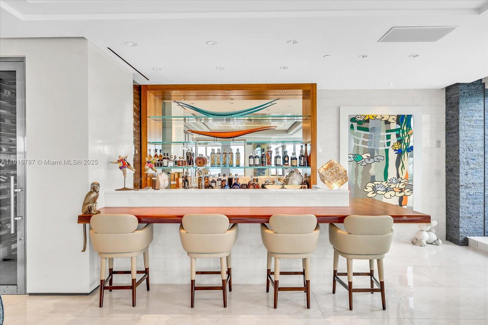 A modern home bar features a wooden counter, four upholstered chairs, and glass shelving — 430 Grand Bay Dr, Key Biscayne FL 33149, KEY BISCAYNE, FL