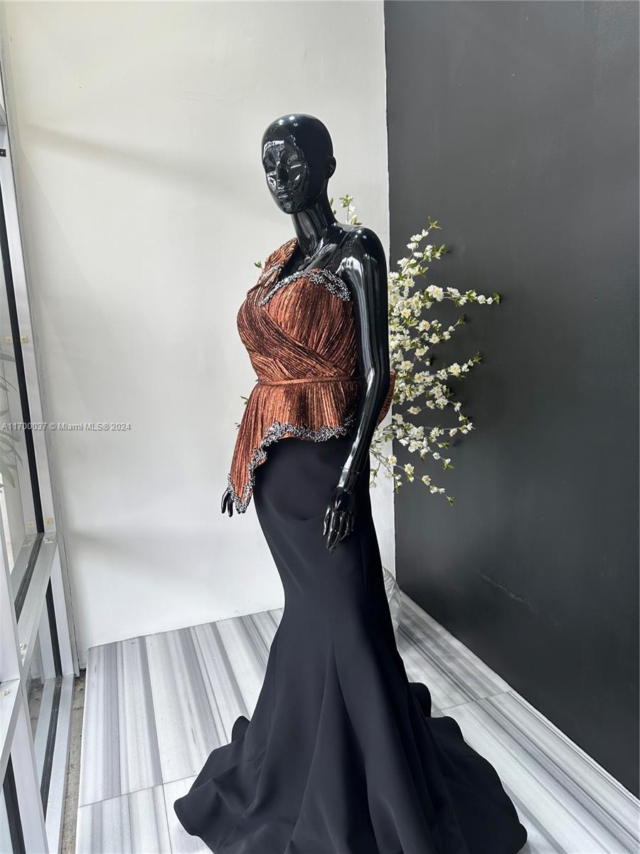A black mannequin wears a pleated copper-colored top and a long black skirt — 14248 SW 8th St, Miami FL 33184, MIAMI, FL
