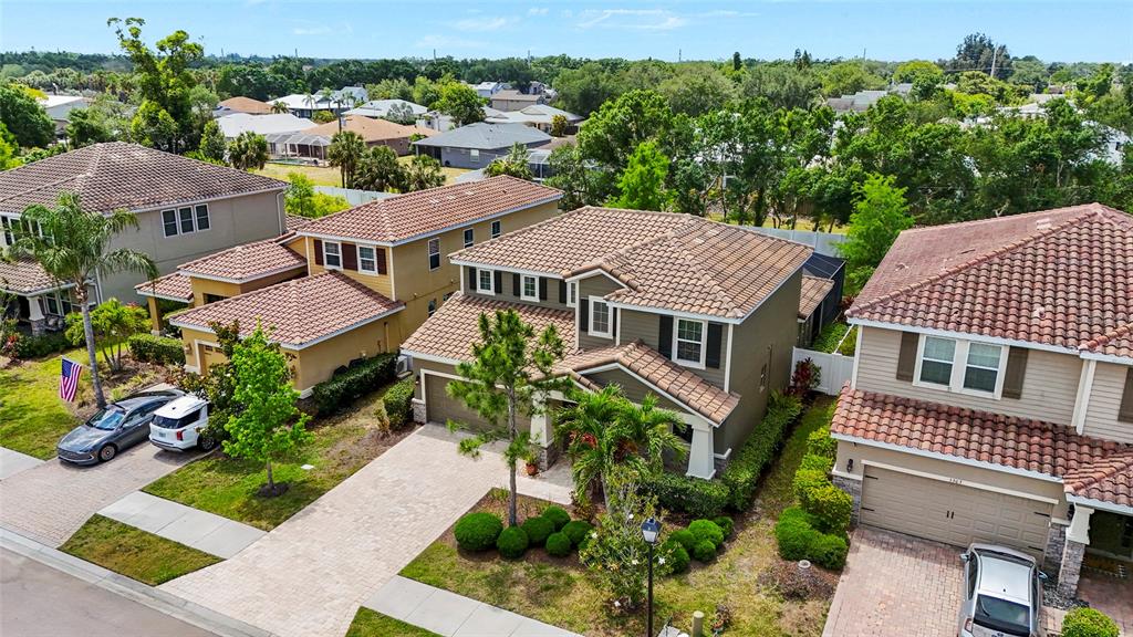An aerial view shows several suburban houses with tiled roofs and paved driveways — 5309 CHARLIE BROWN LANE, SARASOTA, FL