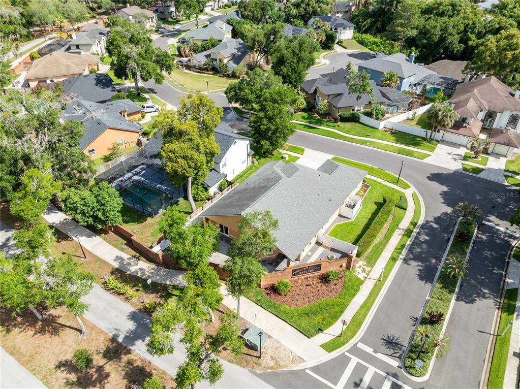 An aerial view shows a residential neighborhood with a community clubhouse and swimming pool — 683 OAK HOLLOW WAY, ALTAMONTE SPRINGS, FL