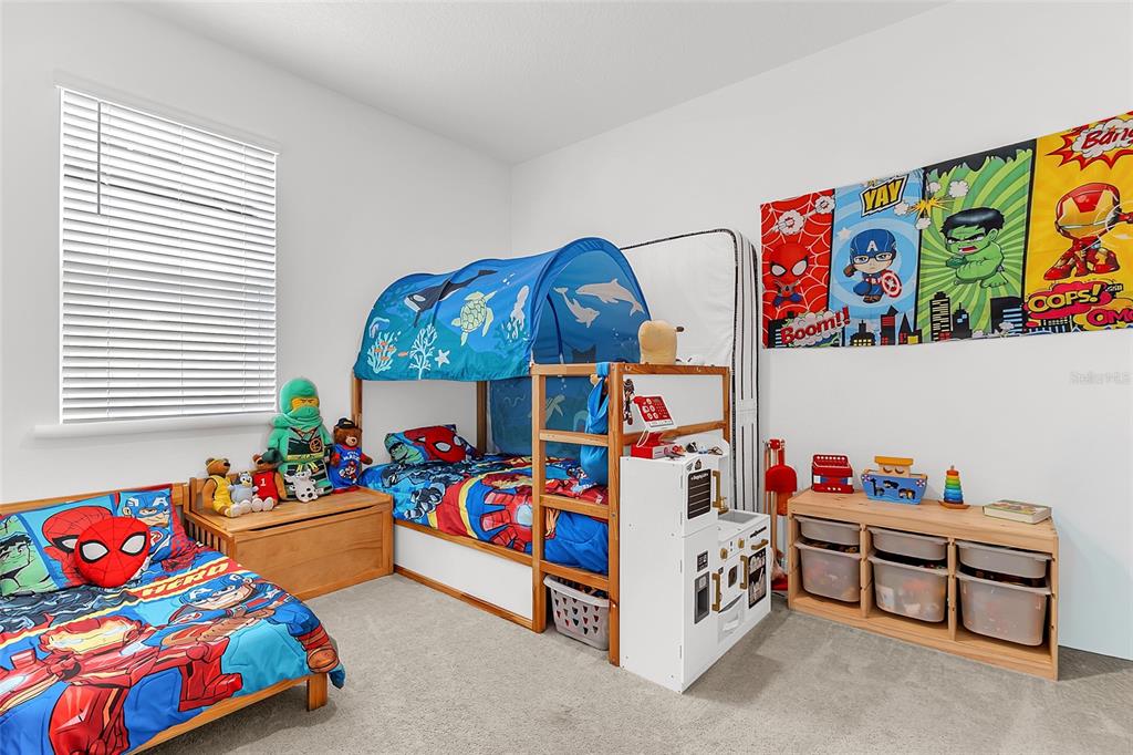 A child's bedroom features a bunk bed with a tent, superhero bedding, and wall art — 1559 GARDINER STREET, HAINES CITY, FL