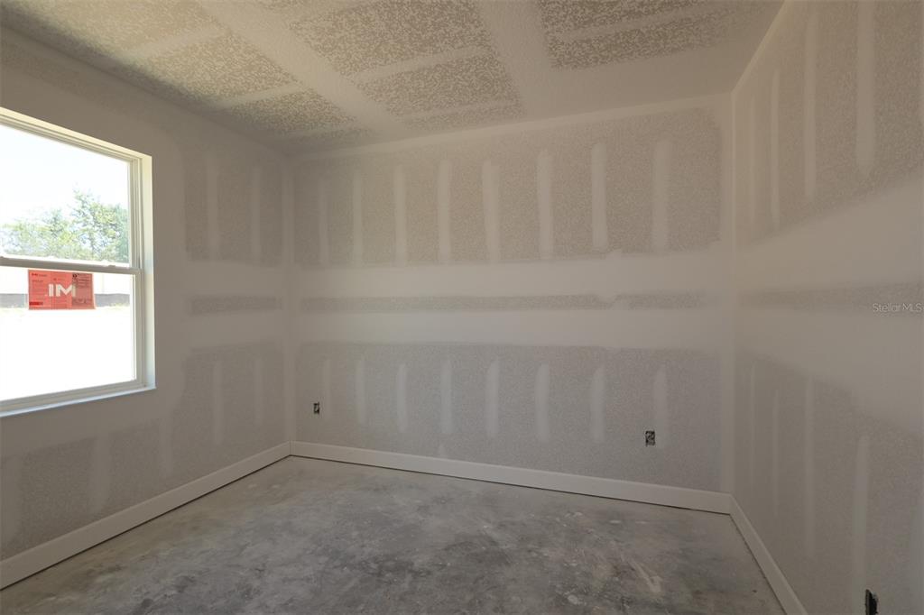 A bathroom features a white vanity with a dark faucet, a mirror, and a glass-paneled door — 3254 WOLF LAKE AVENUE, APOPKA, FL