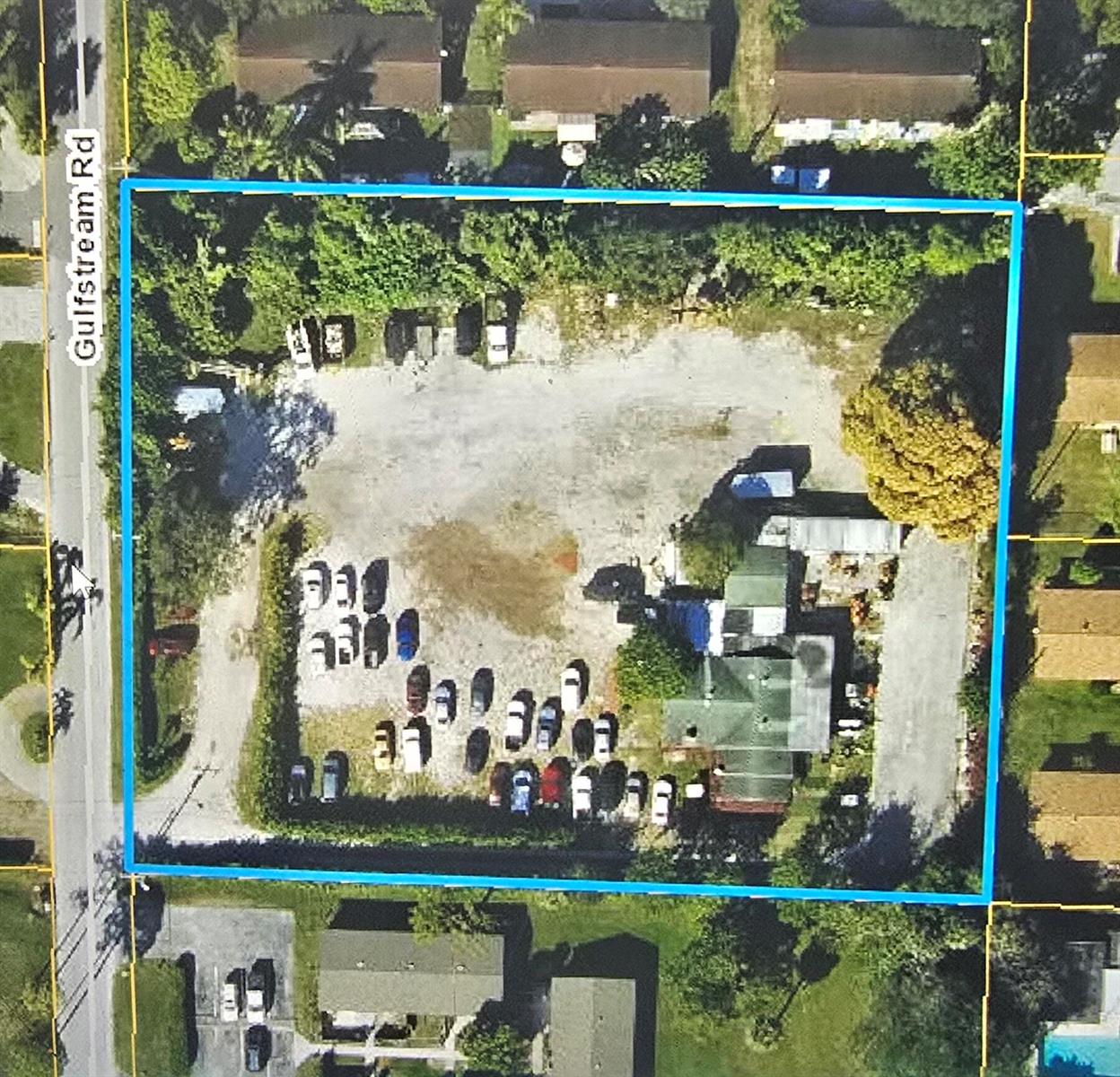 An aerial view shows a rectangular lot with a gravel parking area and a building — 4614 Gulfstream Road, Lake Worth FL 33461, LAKE WORTH, FL