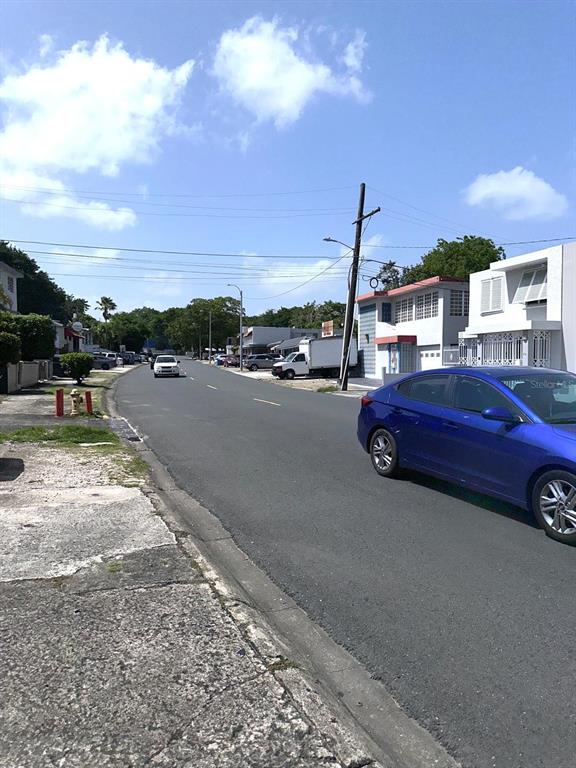 A blue sedan is parked on the side of a paved street in a residential area — 417 ESCORIAL AVENUE, SAN JUAN, PR