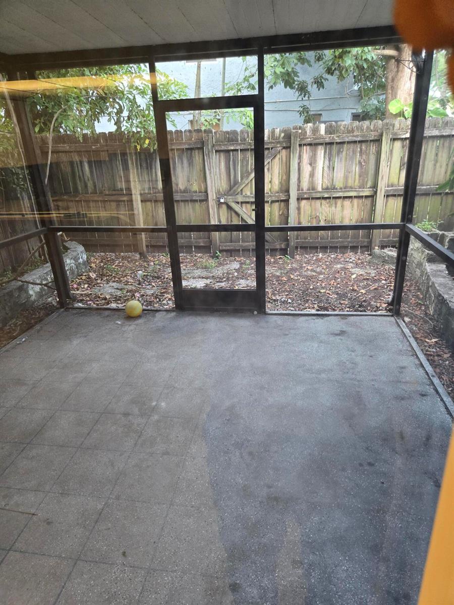A screened-in porch with a concrete floor and a view of a wooden fence — 3714 SW 60th Terrace # 28, Davie FL 33314, DAVIE, FL