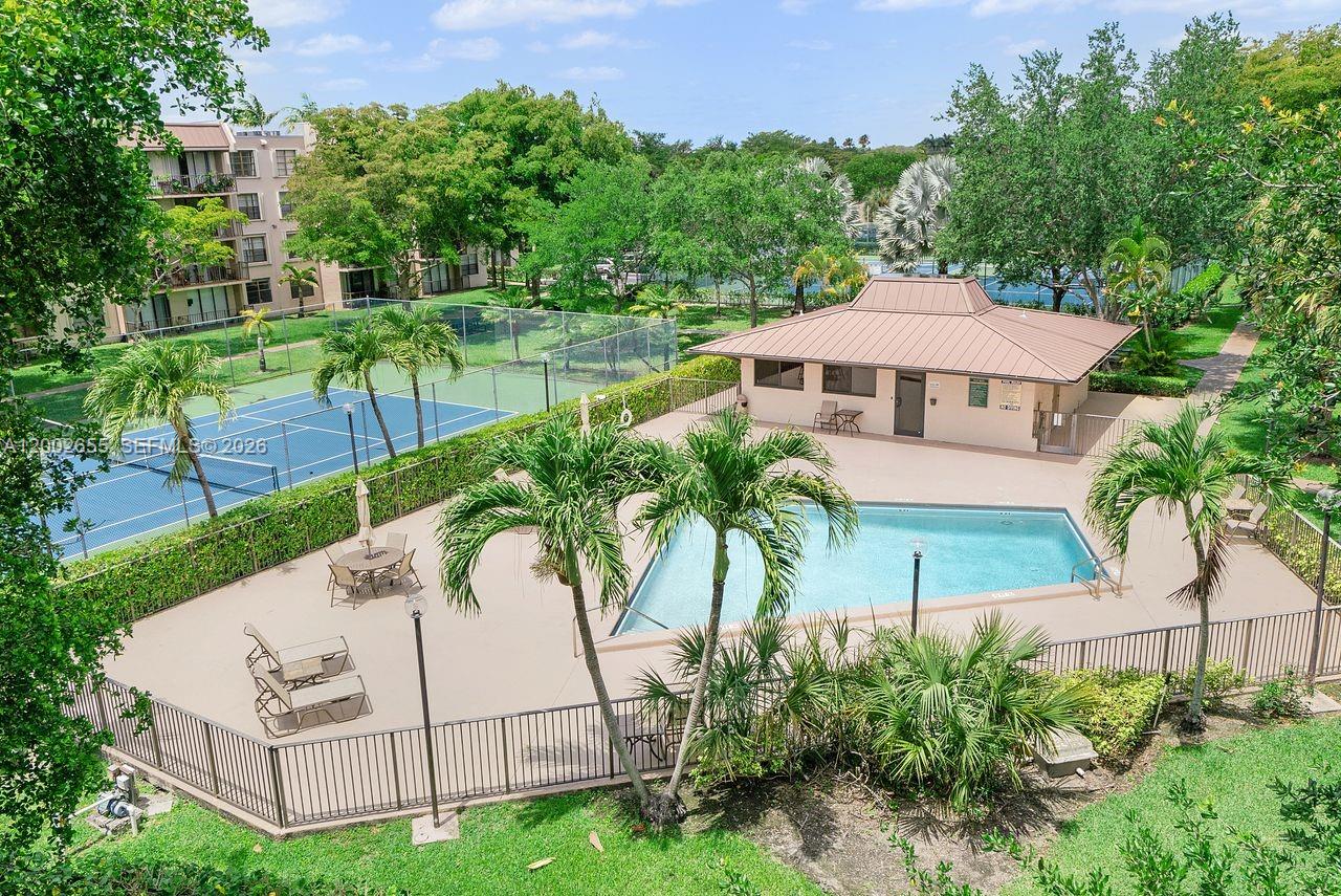 An elevated view of a swimming pool, a tennis court, and a clubhouse building — 13100 SW 92nd Ave, Miami FL 33176, MIAMI, FL