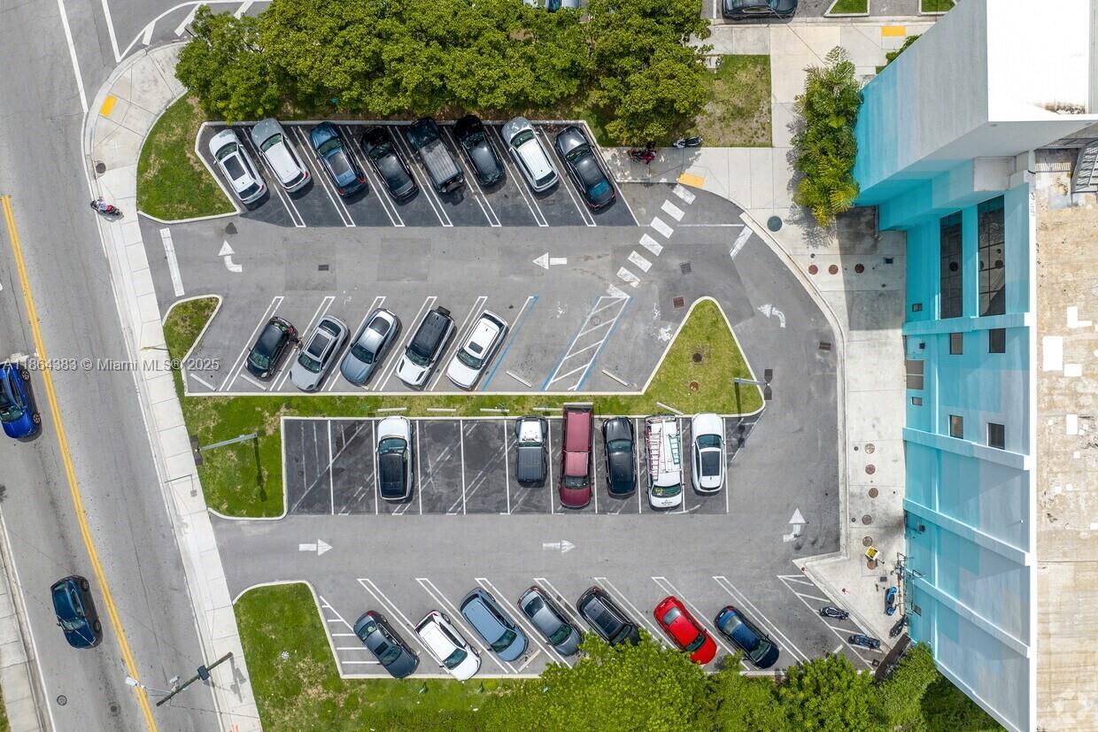 An aerial view shows a parking lot with multiple cars parked in marked spaces — 1900 NE Miami Ct, Miami FL 33132, MIAMI, FL