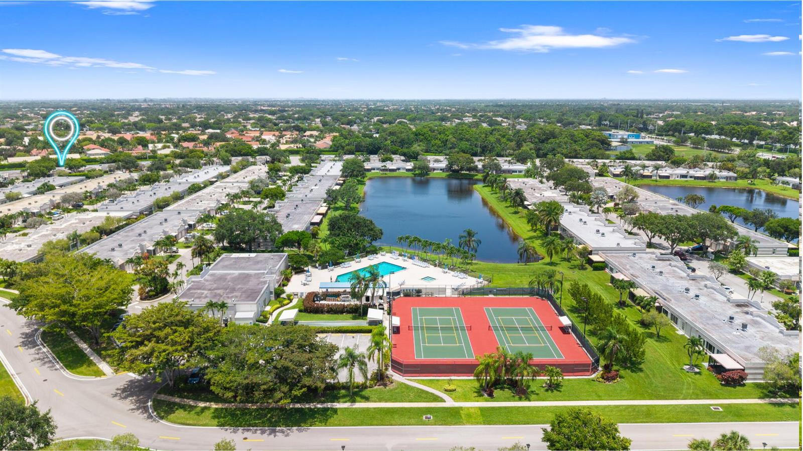 An aerial view shows a residential community with a lake, swimming pool, and tennis courts — 9305 Flynn Circle # 6, Boca Raton FL 33496, BOCA RATON, FL