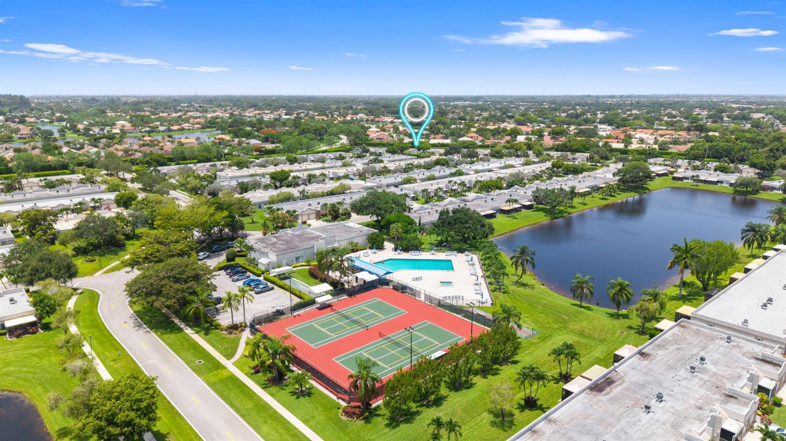 An aerial view shows a community with tennis courts, a swimming pool, and a lake — 9305 Flynn Circle # 6, Boca Raton FL 33496, BOCA RATON, FL