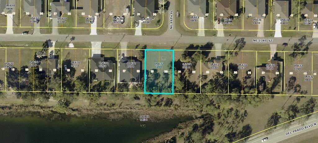This is an aerial map showing a vacant residential lot highlighted in blue — 1810 NE 33RD STREET, CAPE CORAL, FL