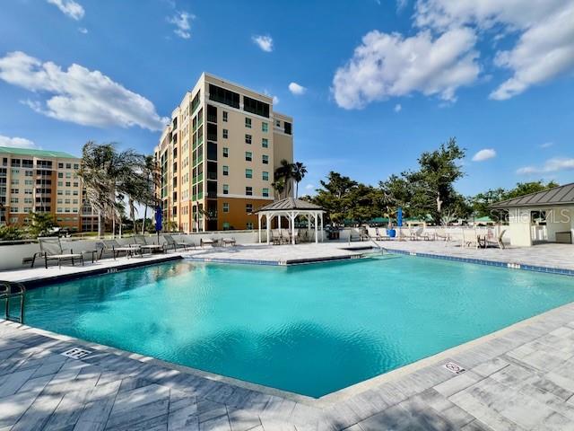 A covered parking area with multiple cars parked under a metal roof structure — 3020 MATECUMBE KEY ROAD UNIT 103, PUNTA GORDA, FL