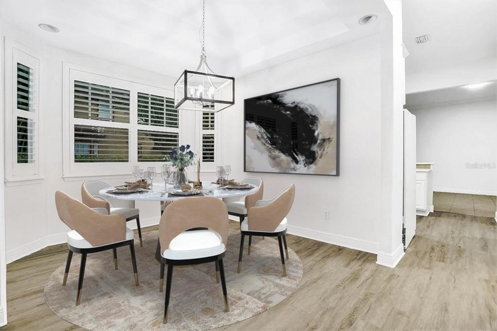 A dining room features a round marble table, four upholstered chairs, and a modern light fixture — 148 S THORNTON AVENUE, ORLANDO, FL