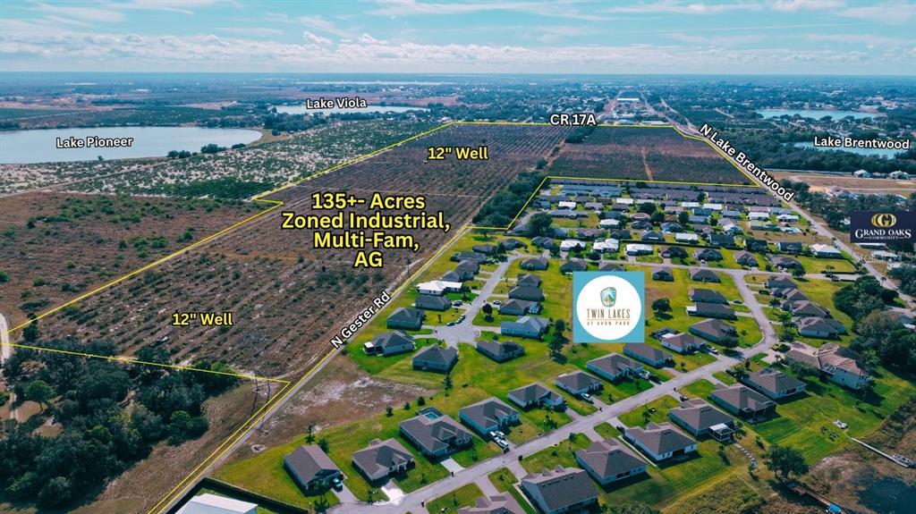 This aerial view shows a large plot of land marked for development near residential neighborhoods — 214 E SHOCKLEY ROAD, AVON PARK, FL