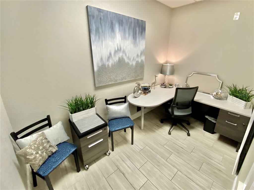 A home office features a desk, two chairs, a filing cabinet, and abstract wall art — 1211 TECH BOULEVARD UNIT 111, TAMPA, FL