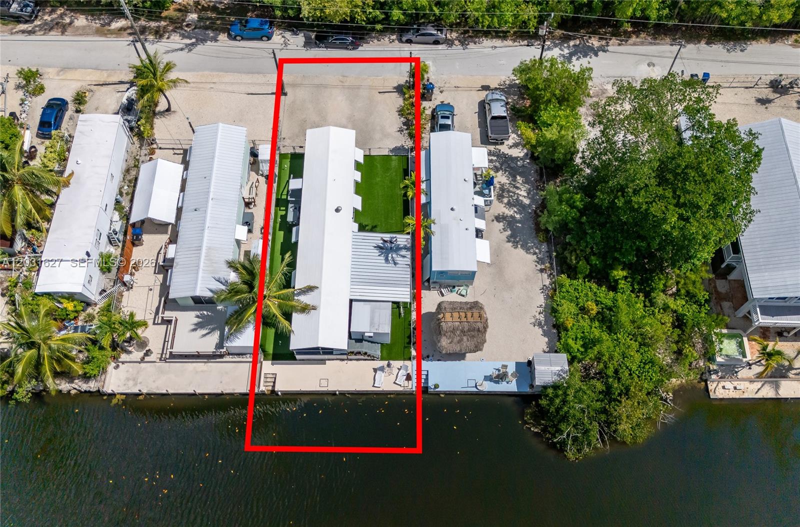 An aerial view shows a narrow waterfront property with a white mobile home and dock — 456 Bowie Ln, Key Largo FL 33037, KEY LARGO, FL