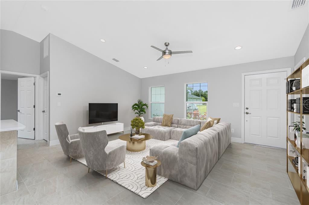 A living room features a sectional sofa, two armchairs, a television, and tile flooring — 2584 CHESLEY ROAD, NORTH PORT, FL