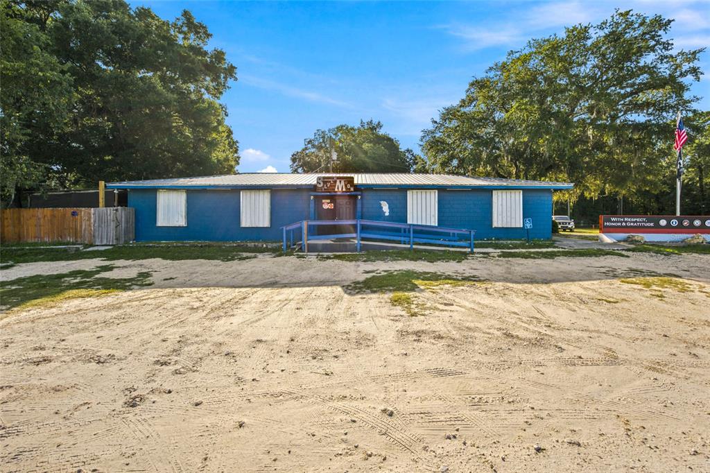A blue, single-story building with a ramp and a sandy parking lot in front — 3025 S US HIGHWAY 41, DUNNELLON, FL