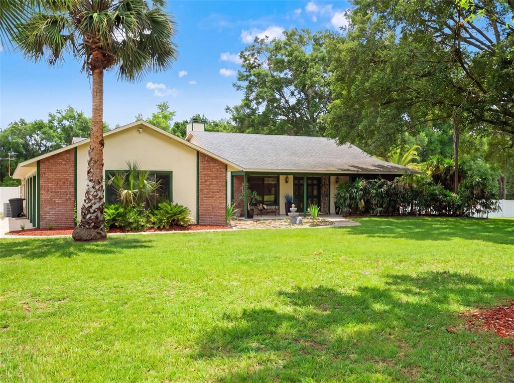 A single-story house with a brick and stucco exterior, a palm tree, and a lawn — 3501 HILL STREAM AVENUE, APOPKA, FL