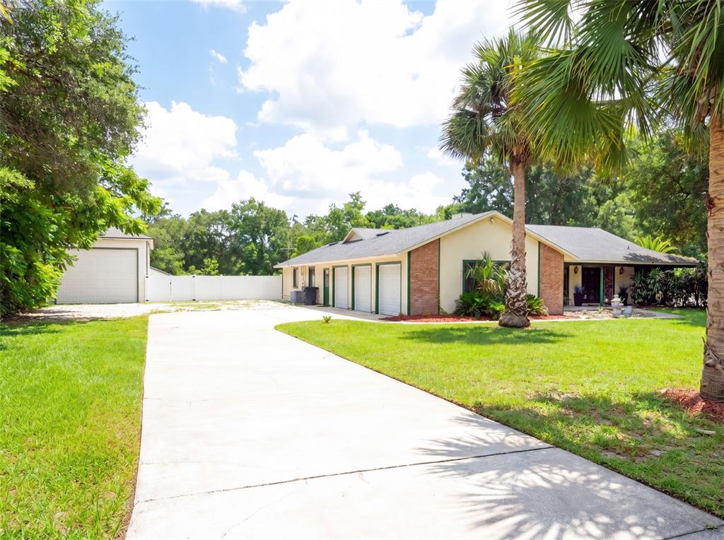 A single-story house with a three-car garage, a detached garage, and a concrete driveway — 3501 HILL STREAM AVENUE, APOPKA, FL