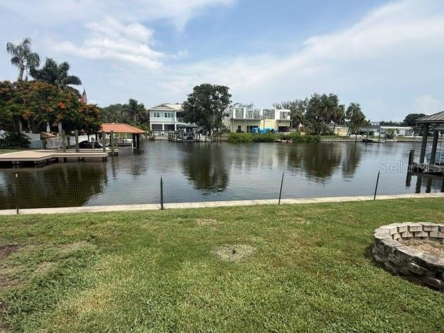 A view of a canal with docks and houses from a grassy backyard — 3945 FONTAINEBLEAU DRIVE, TAMPA, FL