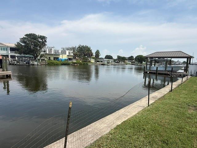 A view of a canal with a boat lift and houses along the shoreline — 3945 FONTAINEBLEAU DRIVE, TAMPA, FL